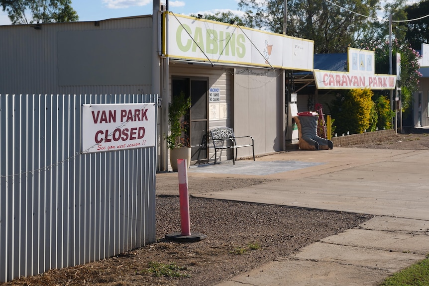 A caravan park with a closed sign at its entrance.