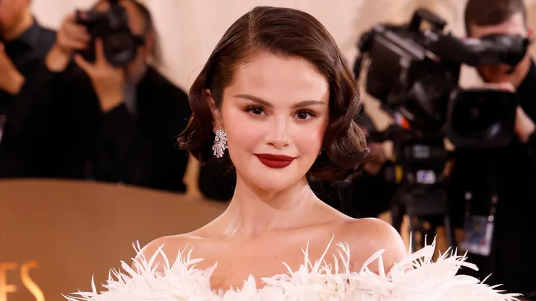 Selena Gomez smiles with red lipstick