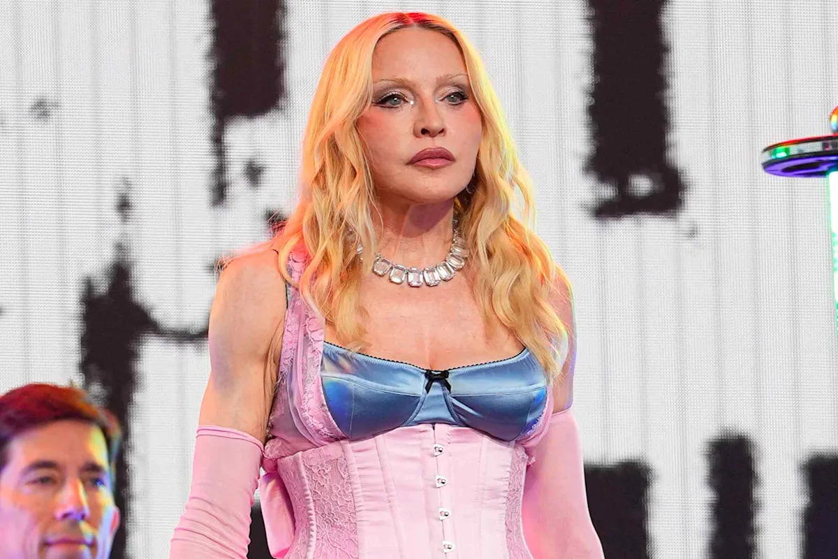Madonna straddles barrier high above Times Square in scary moment from surprise concert
