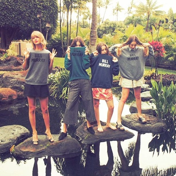 a group of women standing on a table in a garden a group of women standing on a table in a garden