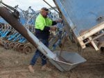 Justin Everett pours Monoammonium Phosphate (MAP) fertiliser into his air seeder at his farm near Brocklesby, Australia, May 5, 2026. REUTERS/Hollie Adams