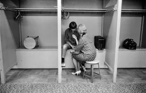 Ringo Starr talking with Marilyn Doerfler as she records the interview in one of the ball players cubbies locker room Candlestick Park San Francisco August 29, 1966