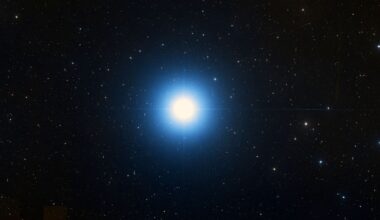 A bright blue star is pictured shining in a black sky surrounded by lesser stars.