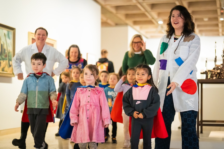 preschool students at Art Gallery of NSW wearing super hereo capes and surrounded by art