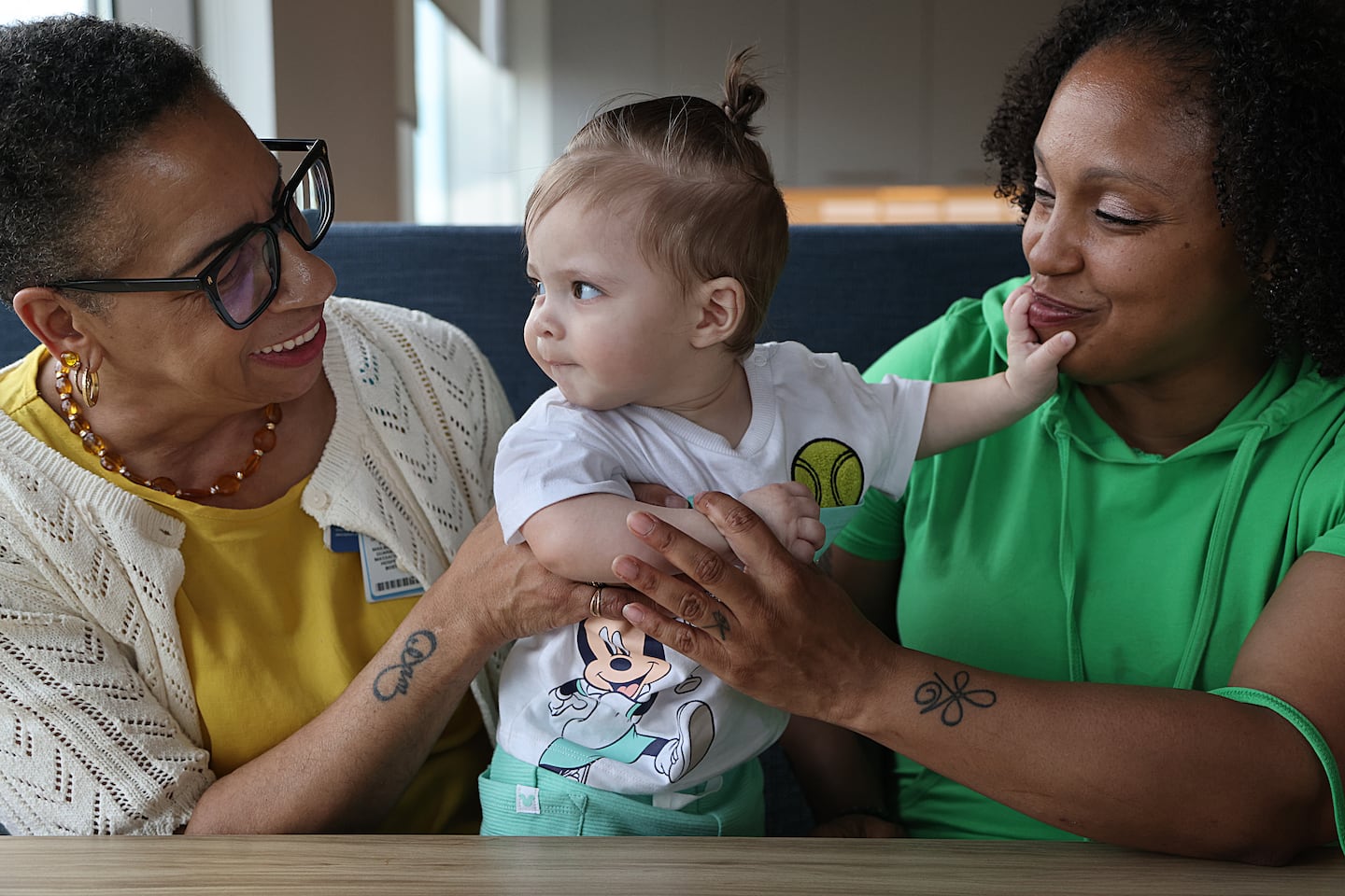 Alea Martinez (right) with her 8-month-old son Sincere Martinez and health worker Joyce Clark in Boston last month.