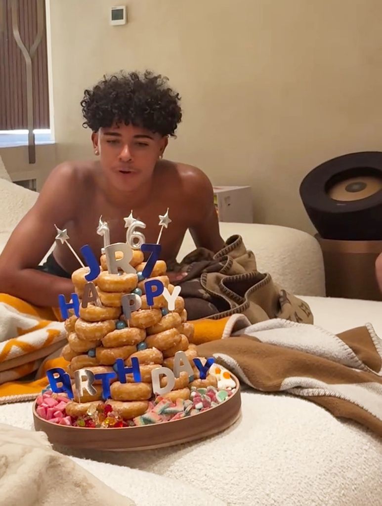 The teenager was all smiles as he blew out the candles on his unique doughnut birthday cake.