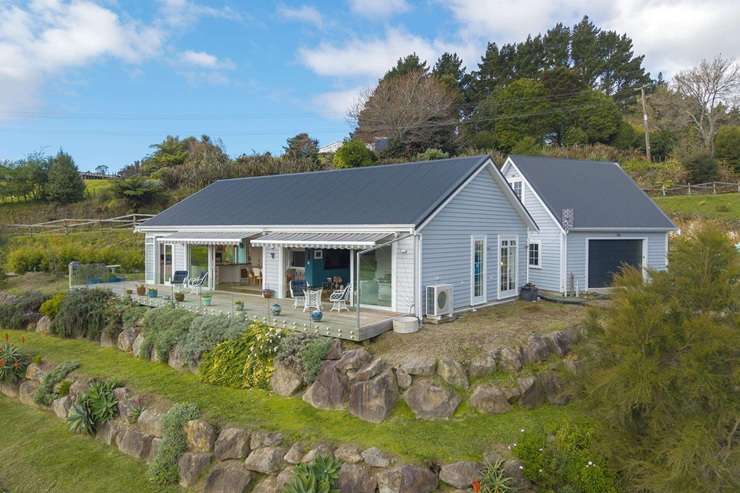 A two-bedroom cottage at 614 Kaitemeko Road, in Welcome Bay, comes with its own special piece of protected bush. Photo / Supplied