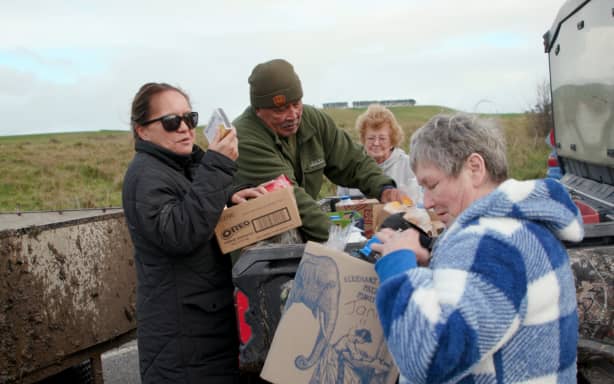 Groceries being unloaded as locals band together to help storm-hit Wairarapa residents.