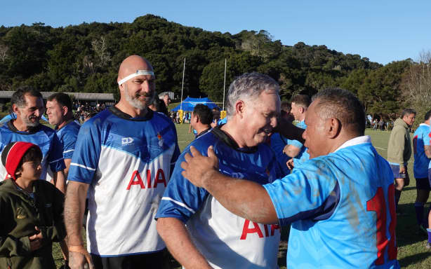 Sports Minister Mark Mitchell embraces ex-All Black and Samoa rep Ofisa Tonu’u after the match.
