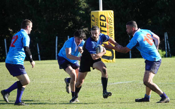 Brian George, from Parliamentary security, dodges a trio of Russell defenders.