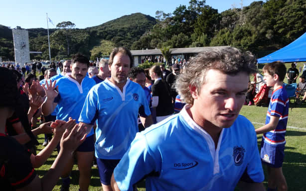 Western Sharks player Tony Stokes runs onto the pitch for Russell ahead of the big game.