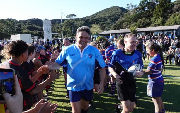 Team captains Taine Randell (Russell Penguins) and Simon Watts (Parliamentary Rugby Team) lead their teams onto the pitch.