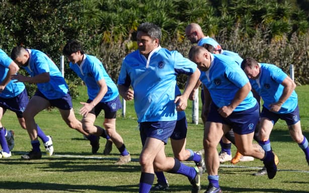 Russell captain and ex-All Black Taine Randell leads the team in a warm-up.