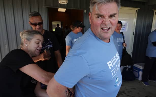 Ouch! TVNZ sports presenter Andrew Saville gets his shorts adjusted by Jodi Osborne.