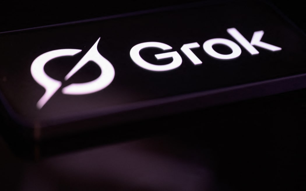 The Grok logo is displayed on a mobile phone screen in this photo illustration in Brussels, Belgium, on February 22, 2026. (Photo by Jonathan Raa/NurPhoto) (Photo by Jonathan Raa / NurPhoto via AFP)