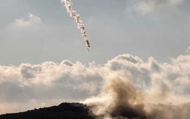 A flare fired by the Israeli military lands over the highlands of the area of Ali al-Taher as seen from nearby Marjayoun (Marjeyoun) in southern Lebanon on June 14, 2026. Israel struck Beirut's southern suburbs on June 14, killing three people, in response to what it said was Hezbollah fire at northern Israel, while its military also carried out broader strikes on southern Lebanon. The latest escalation came amid expectations that a deal between the US and Iran to end the Middle East war could be imminent, but Iranian chief negotiator Mohammad Bagher Ghalibaf said there was "no point" in continuing peace talks with Washington after the strike. (Photo by AFP)