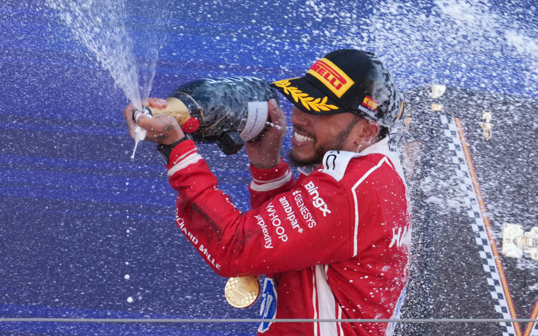 Ferrari's British driver Lewis Hamilton celebrates on the podium after winning the Catalonia Formula One Grand Prix at the Circuit de Catalunya in  Barcelona, 2026.
