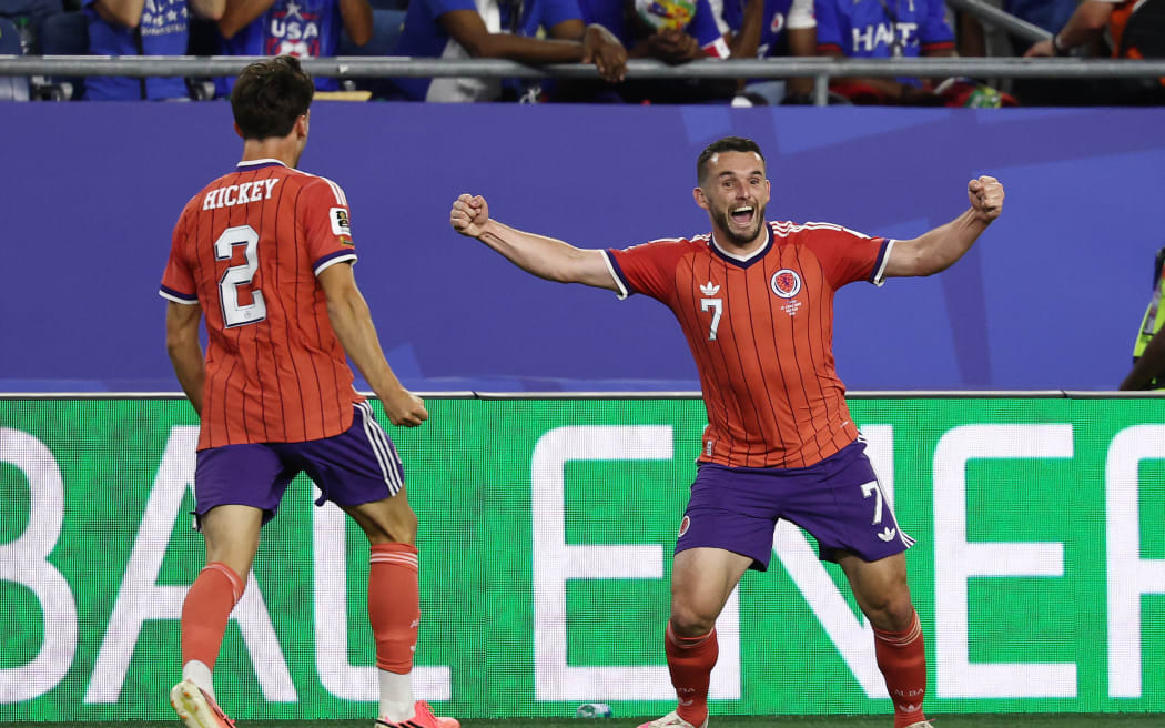 Scotland's midfielder John McGinn (No 7) celebrates with teammate defender Aaron Hickey after scoring his team's first goal during the 2026 World Cup Group C football match against Haiti in Boston, June 13, 2026. (Photo by FRANCK FIFE / AFP)