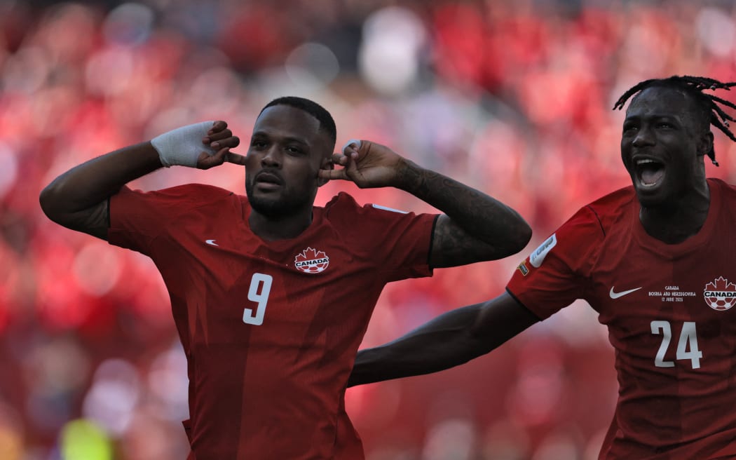 Canada's forward #09 Cyle Larin (L) celebrates after scoring a goal during the 2026 World Cup Group B football match between Canada and Bosnia and Herzegovina at the Toronto Stadium in Toronto on June 12, 2026. (Photo by Cole Burston / AFP)