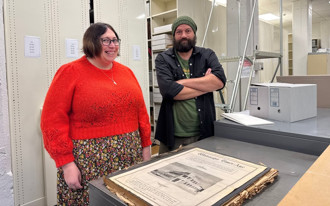 Masterton council content and access manager Stephnie Burton and Heritage Digitisation Specialist Adam Simpson with a copy of the first copy of the Wairarapa Times-Age, printed in 1938.