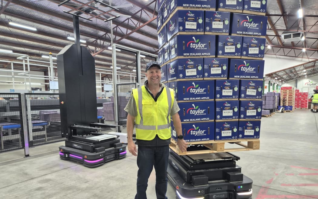 Cameron Taylor with an AMR robotic forklift.