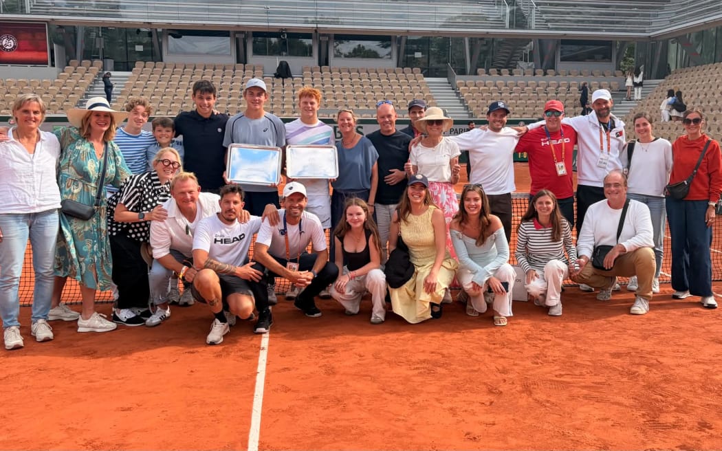 Jamie McKenzie (centre right) and doubles partner Vincent Jakob Reisash, with supporters, after their French Open boys' doubles triumph at Roland Garros.