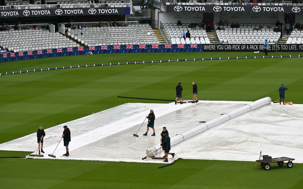 The rain covers are pictured on the square before day three of the first cricket test match between England and New Zealand at Lord's cricket ground in London on June 6, 2026. (Photo by Glyn KIRK / AFP) / RESTRICTED TO EDITORIAL USE. NO ASSOCIATION WITH DIRECT COMPETITOR OF SPONSOR, PARTNER, OR SUPPLIER OF THE ECB