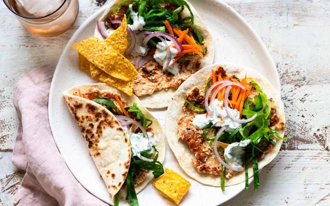 Smashed chicken tacos with coriander and lime sour cream.