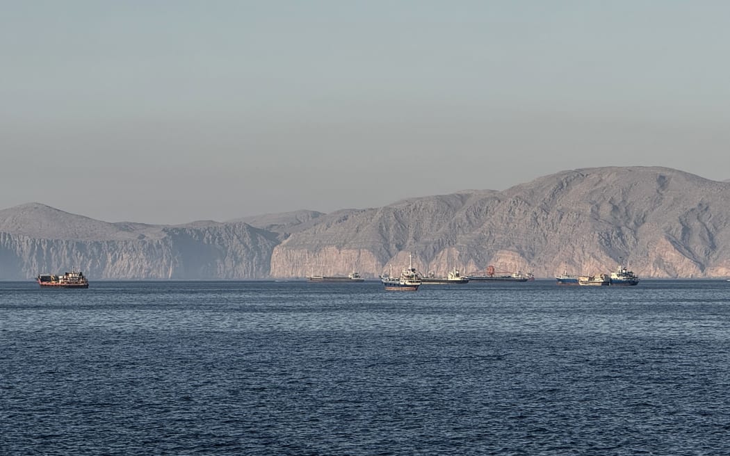 Vessels are seen anchored in the Strait of Hormuz, off the port city of Khasab on Oman’s northern Musandam Peninsula on May 17, 2026. Washington, locked in conflict with Tehran since US and Israeli forces launched major strikes on the Islamic republic beginning February 28, has struggled to break an impasse and make any progress toward ending a war that has shaken the Middle East and sent energy prices climbing. The war has led to an effective blockade of the critical Strait of Hormuz, through which some 20 percent of global oil exports pass in peacetime, and has drawn neighbors Israel and Lebanon into a deadly side conflict. (Photo by AFP) /