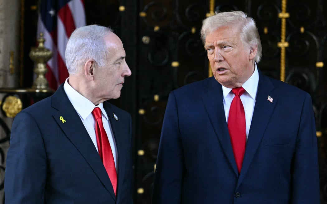 US President Donald Trump (R) greets Israeli Prime Minister Benjamin Netanyahu (L) upon arrival at Trump’s Mar-a-Lago residence in Palm Beach, Florida, on December 29, 2025. (Photo by Jim WATSON / AFP)