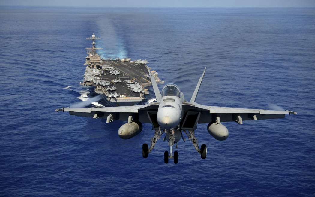 Pacific Ocean, April 24, 2013 - An F/A-18E Super Hornet participates in an air power demonstration over the aircraft carrier USS John C. Stennis. (Photo by Stocktrek Images / StockTrek Images via AFP)