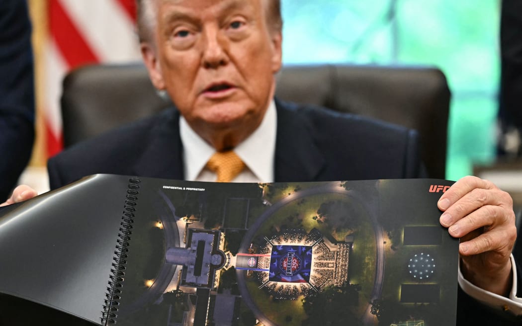 President Donald Trump shows a rendering of the upcoming 