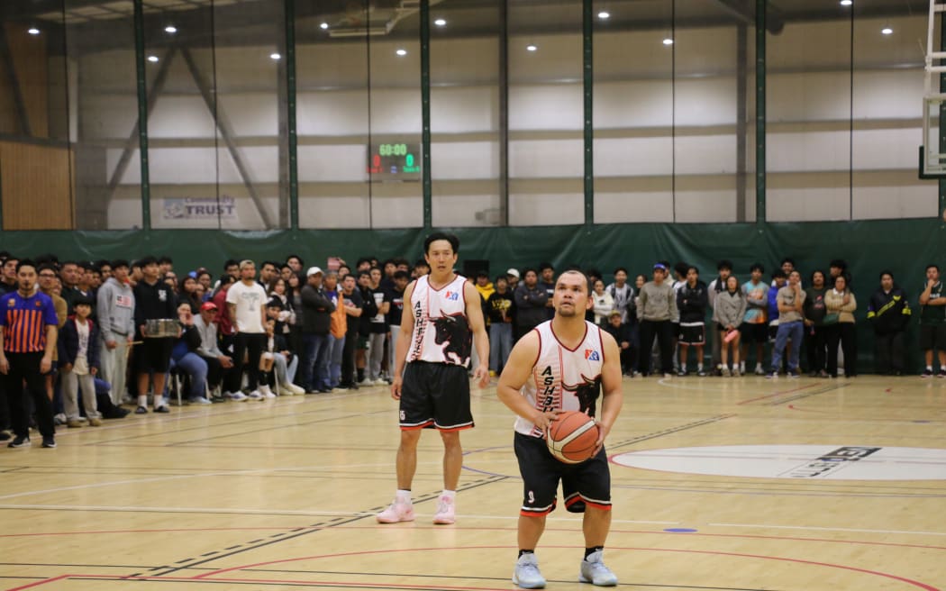 Feeling the pressure - Ashburton's legends team player Michael Boston (right) preps a shot as Randy Buenafe and the crowd watch on.