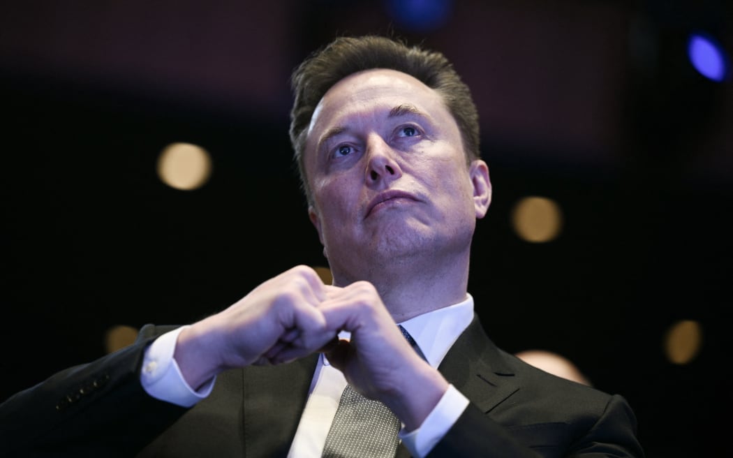 (FILES) Elon Musk looks on as US President Donald Trump speaks at the US-Saudi Investment Forum at the John F. Kennedy Center for the Performing Arts in Washington, DC on November 19, 2025. Elon Musk's lawsuit accusing high-profile artificial intelligence company OpenAI of betraying its non-profit mission heads for trial on April 27, 2026 with the selection of jurors. The legal clash in a courtroom across the bay from San Francisco pits the world's richest person against a startup Musk once backed and now competes with in the booming AI sector.