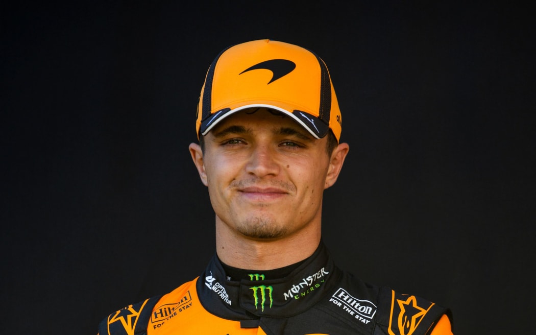 Lando Norris wearing a McLaren hat which features the kiwi emblem.
