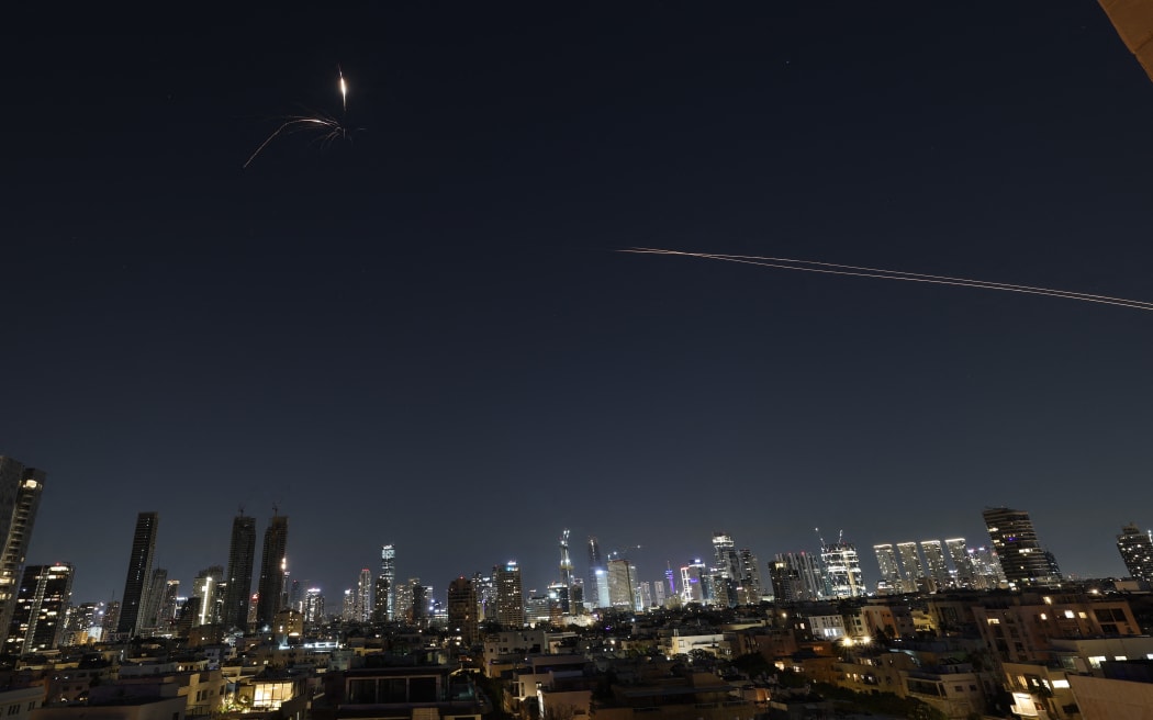 Rocket trails are seen in the sky amid a fresh barrage of Iranian missile attacks above the Israeli coastal city of Tel Aviv on March 3, 2026.