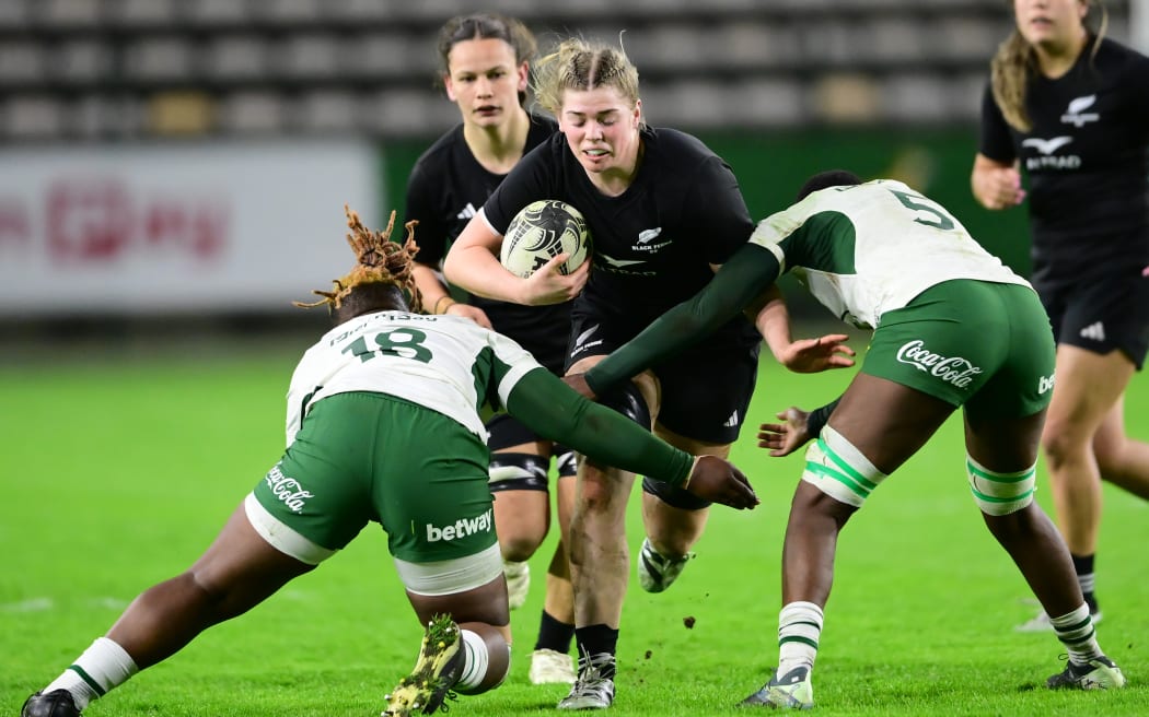 Sam Taylor of the Black Ferns XV getting tackled in their match against South Africa.