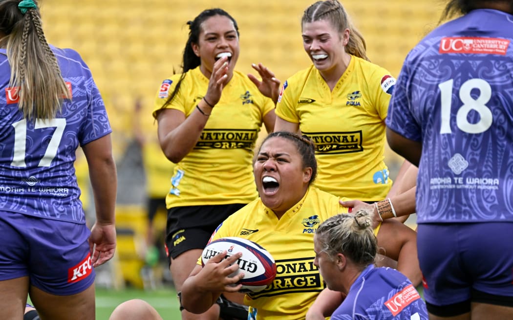The Hurricanes Poua celebrate a try.