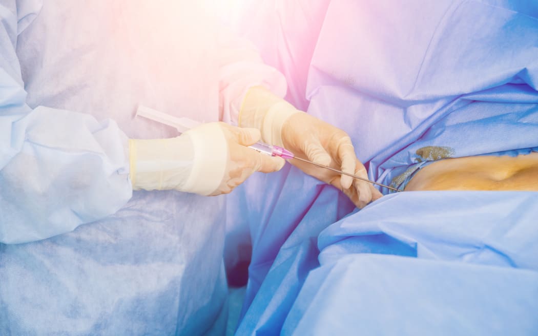 Arthroscope surgery. Orthopedic surgeons in teamwork in the operating room with modern arthroscopic tools. Hospital background