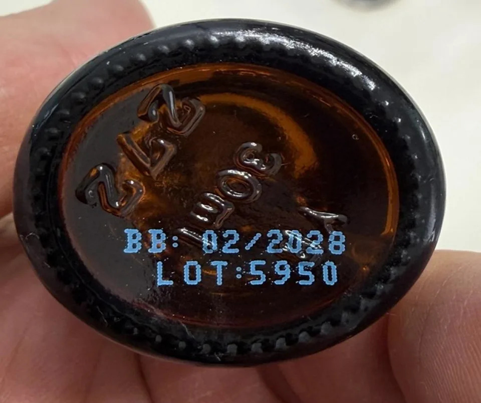 Brown bottle base showing BB 02/2028 and LOT 5950 in blue print.