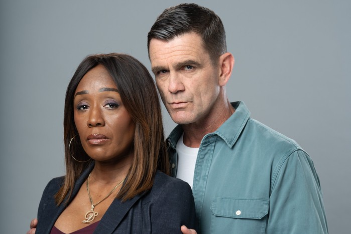 Jack puts his hands on Denise's shoulders in a scene from EastEnders