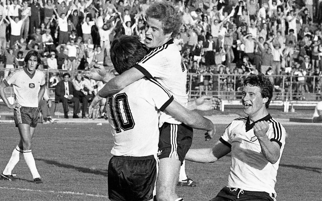 Steve Sumner (10) congratulated by Grant Turner and Steve Woodin (R) after scoring for the All Whites as New Zealand drew 3-3 with Australia in the first elimination game of their pool in the 1982 Soccer World Cup at Mt Smart Stadium, 25 April 1981. © Photo: Anthony Phelps