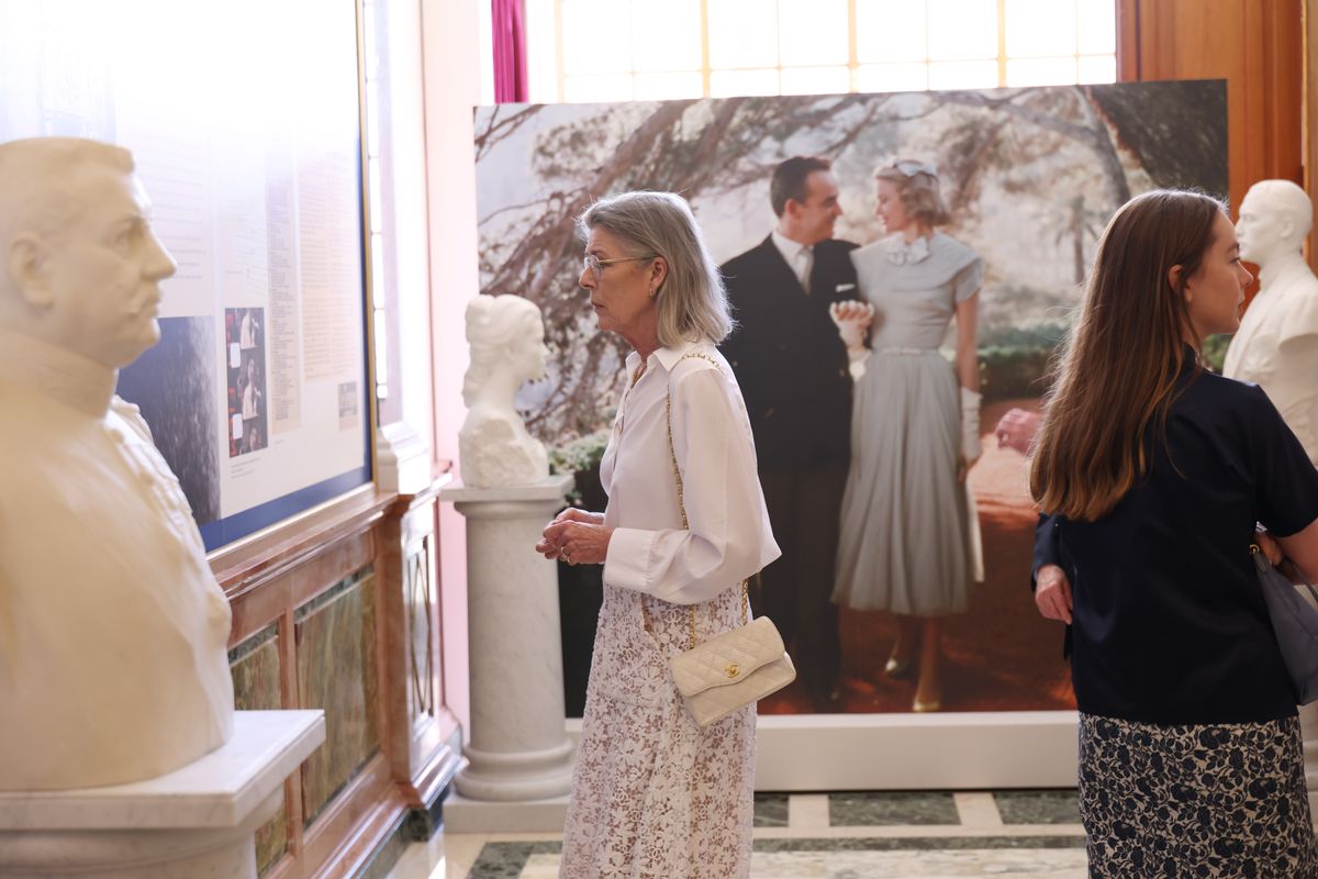 Princess Caroline of Monaco embraced timeless elegance in a crisp white blouse and a delicate floral lace Chanel skirt for the special exhibition honoring her parents.