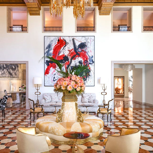 Luxurious hotel lobby with vibrant artwork and elegant furnishings.