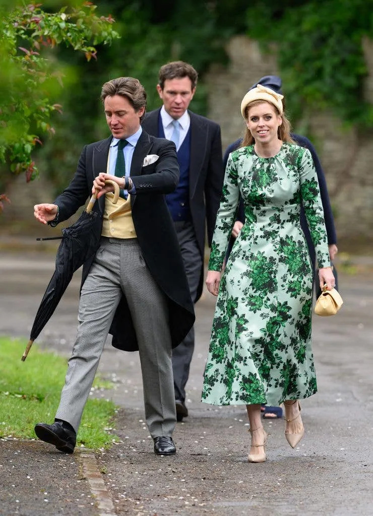 Beatrice added to her look with beige heels and a cream handbag