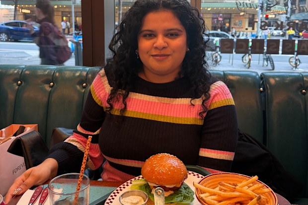 Madhurima Haque sitting in front of food