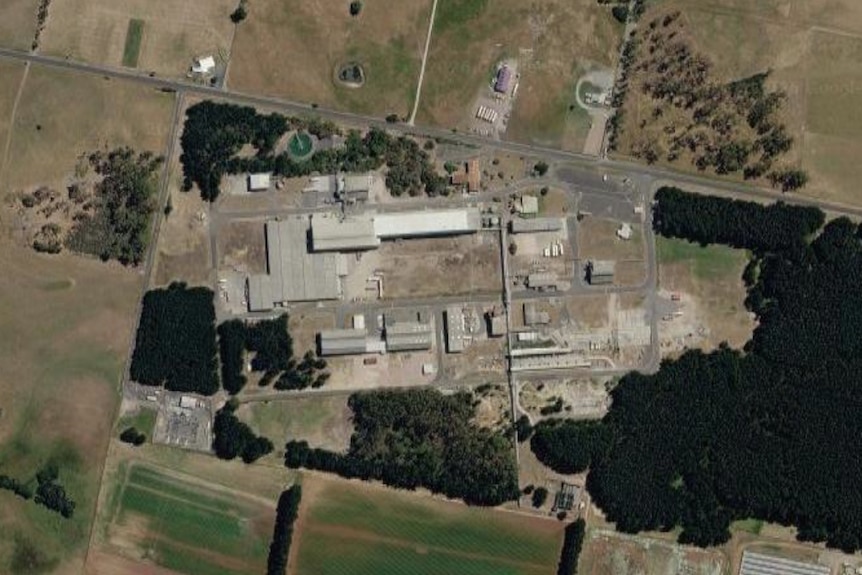 A satellite image of an industrial site, surrounded by agricultural land.