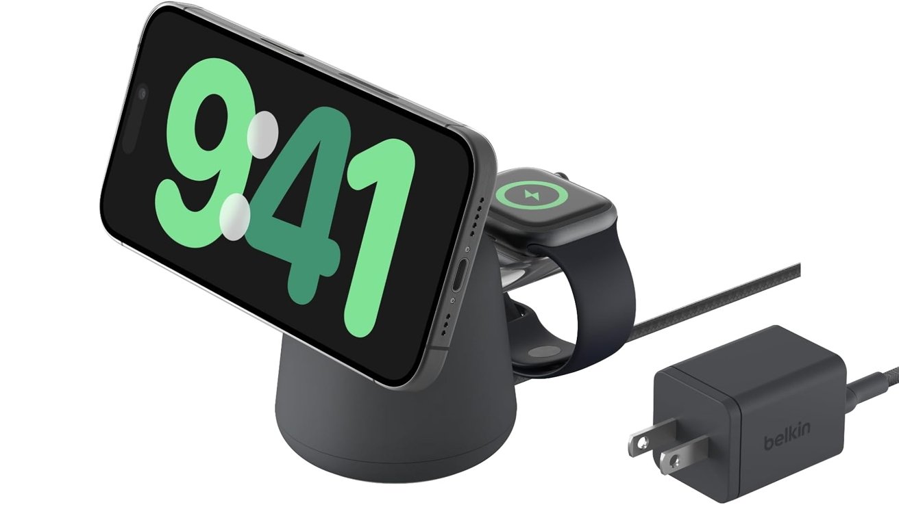 Black Belkin charging stand holding a smartphone showing 9:41 and an Apple Watch, with a connected power adapter and cable on a white background