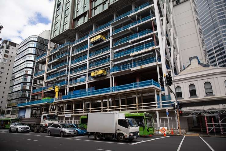 Work on the Seascape apartment tower, left, in Auckland’s CBD stopped in 2024. The tower and other properties owned by developer Shundi Customs are being sold by the receivers. Photo / Michael Craig