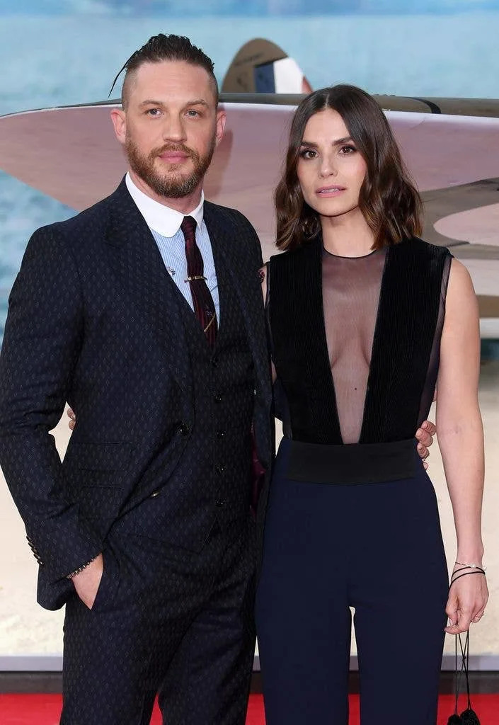 Man and women posing on red carpet